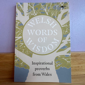 Book titled 'Welsh Words of Wisdom' with a tree design on a purple background