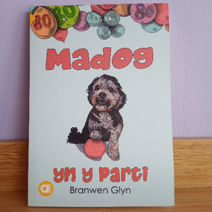 Book cover with a dog illustration and colorful buttons on a light blue background
