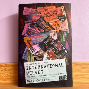 The image displays the cover of the book titled "International Velvet - How Wales Conquered the 90s Charts" by Neil Collins. The cover features a visually engaging and colorful design, consisting of various playful and vintage-style graphic elements such as old-fashioned movie posters, concert tickets, and record charts.