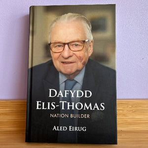 Book cover with an older man's portrait and text on a purple wall background