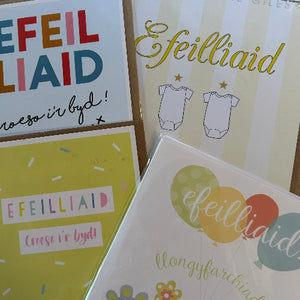 Collection of greeting cards with Welsh text and designs.