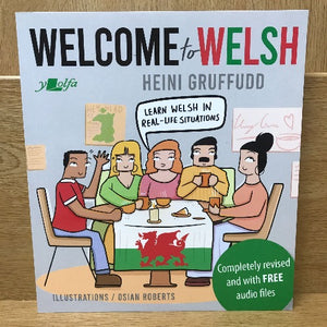 The cover of the book 'Welcome to Welsh' by Heini Gruffudd, featuring an illustration of three people sitting around a table with Welsh flags, indicating a scene of learning or studying Welsh.