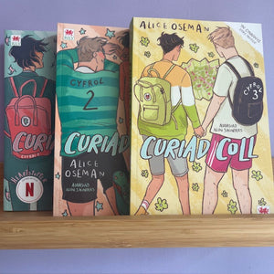 Three books titled 'Curiad' by Alice Oseman on a shelf with a purple background.