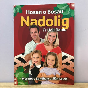 A book cover of 'Hosan o Bosau Nadolig i'r Holl Deulu' featuring a family playing a game on a Nintendo DS. The children are smiling and posing, and the adults have a cheerful expression.