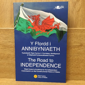 A book cover of 'Y Ffordd i ANNIBYNAETH - The Road to Independence' featuring the Welsh flag and a red dragon.