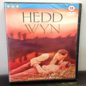 DVD cover of 'Hedd Wyn' featuring a man and a woman lying down, with a sunset in the background and text indicating 'with English subtitles'.