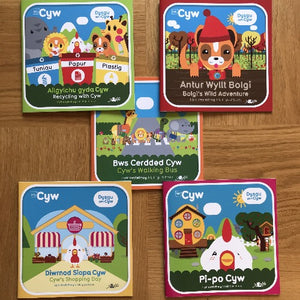 A collection of colorful children's book covers with Welsh text and illustrations, featuring a character named Cyw and various animals.