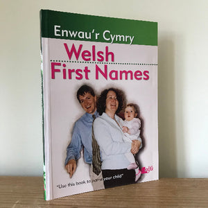 A book titled 'Enwau'r Cymry Welsh First Names' with a cover image featuring two adults and a child.