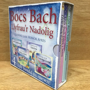 A box of 4 Bocs Bach children's board books with Christmas themed illustrations, including titles and authors.