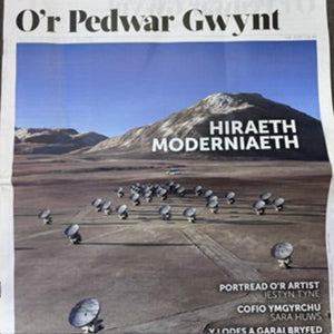 A square art print or poster featuring a desert landscape with a mountain, many satellite dishes, and large overlaid text reading 'HIRAETH MODERNIAETH.' The top also reads 'O'r Pedwar Gwynt.