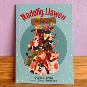 Book cover with illustration of a woman and animals, titled 'Nadolig Llawen' on a light blue background.