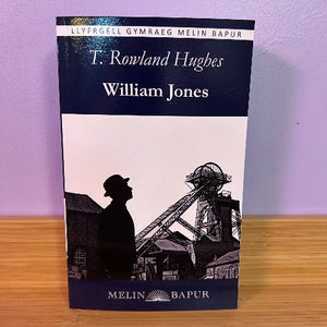 Book titled 'William Jones' by T. Rowland Hughes with a silhouette of a miner and mining equipment on a purple background.