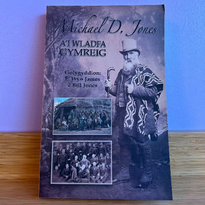 Book cover with a historical photograph of a man and group on a wooden surface.