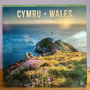 Calendar cover featuring a scenic view of a lighthouse on an island with 'Cymru Wales' text.