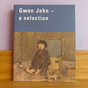 Book titled 'Gwen John - a selection' with an illustration of a child on the cover, placed on a wooden surface.