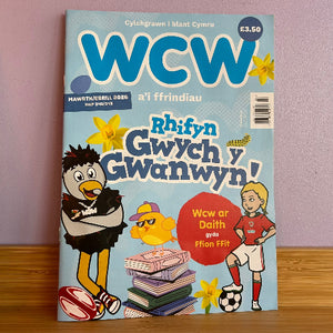 Magazine cover with cartoon characters and text on a wooden surface and purple wall background
