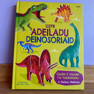 Children's book with dinosaur illustrations on a yellow background