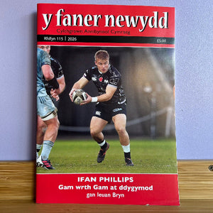 Magazine cover featuring a rugby player on a grass field with a red and white header.