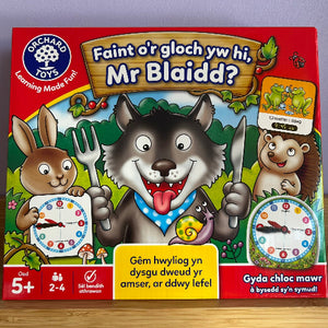 Children's board game box with cartoon wolf, rabbit, and bear characters on a red background.