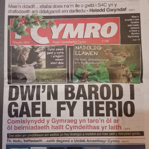 Newspaper with a prominent Y Cymro advertisement on a gray background