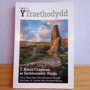 Book titled 'Y Traethodydd' with a stone monument on the cover, placed on a wooden surface.