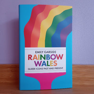 Book titled 'Rainbow Wales' with a rainbow design on a purple background