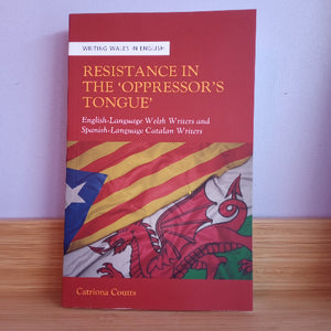 Book titled 'Resistance in the Oppressor's Tongue' with a red cover and dragon design on a wooden surface.