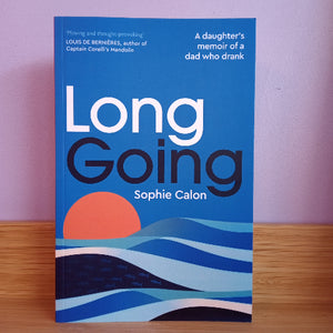 Book titled 'Long Going' by Sophie Calon with a blue cover and sunset design on a wooden surface.