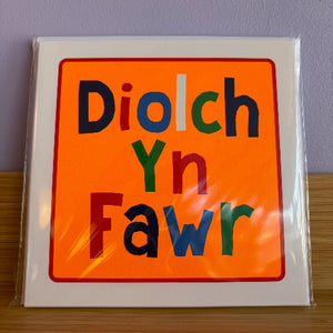 Colorful card with 'Diolch Yn Fawr' text on an orange background, wrapped in clear plastic.