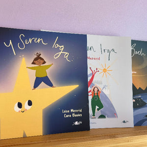 Children's books with colorful illustrations on a wooden surface