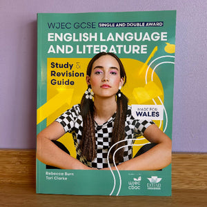 WJEC GCSE English Language and Literature study guide on a wooden surface with a purple wall background