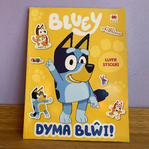 Book cover of 'Bluey' with stickers on a yellow background