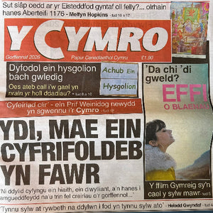 A front-facing view of a Welsh newspaper titled “Y Cymro” with multiple printed articles and advertisements visible on the page.