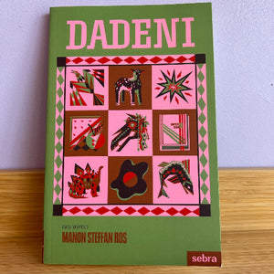 The book cover of 'Dadeni' by Manon Steffan Ros, published by Sebra. The cover features a sage green background with a central pink and brown geometric collage of animals and abstract shapes, with the title 'DADENI' in bold pink letters at the top.