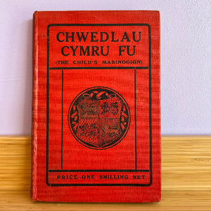 A vintage Welsh book titled 'CHWEDLAU CYMRU FU (THE CHILD'S MABINOGION)' with a red cover and black text.