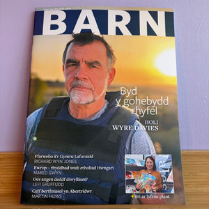 Magazine cover with a man's face on the front, featuring text and a small inset photo.