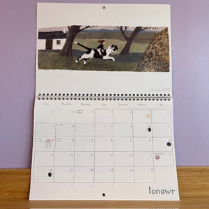 Calendar with a cat illustration on a purple wall