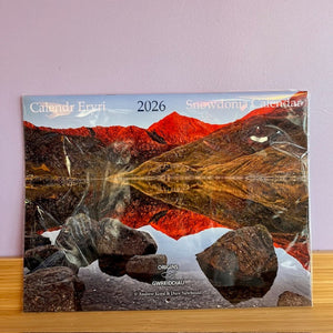 Calendar with a mountain and lake reflection design on a light purple background