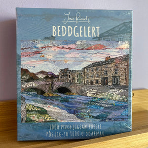 Jigsaw puzzle box with a scenic design on a wooden surface
