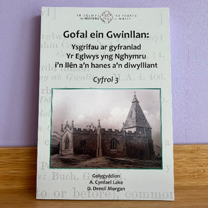 Booklet with a church image on a wooden surface and purple background