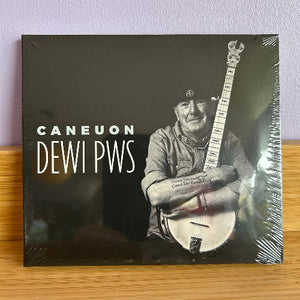 CD cover with a person holding a banjo and text 'Caneuon Dewi Pws' on a wooden surface.