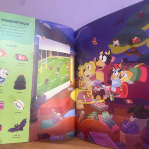 Open book showing cartoon characters in a living room with a football game on TV.