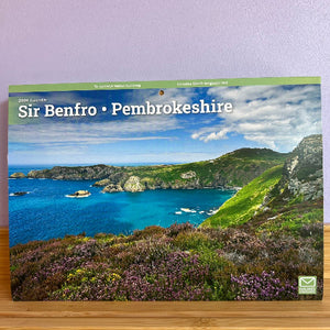 Calendar cover featuring a scenic view of Pembrokeshire with mountains and sea.