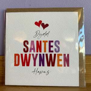 Card with colorful text and hearts on a white background