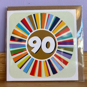 Greeting card with colorful design and number 90 on a purple background