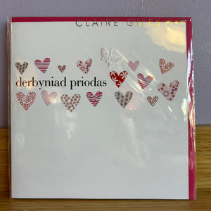 Card with heart designs and 'Derbyniad Priodas' text on a white background