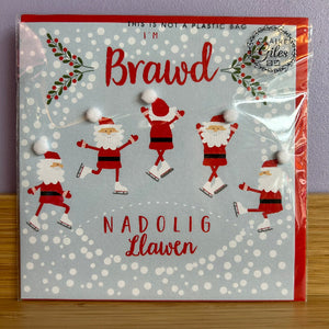 Packaged card with Santa Claus illustrations and text on a gray background