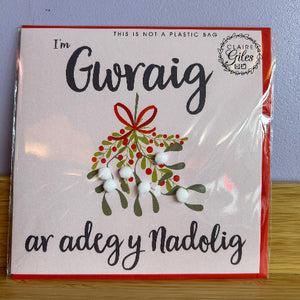 Packaged card with mistletoe design and text on a white background