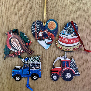 Collection of colorful Christmas ornaments on a wooden surface