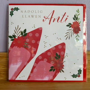 Christmas card with red and pink designs and floral elements on a white background.